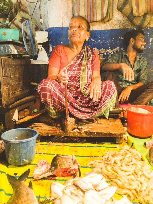 famous fish market in kolkata: a woman selling fish in Bakultala, Behala