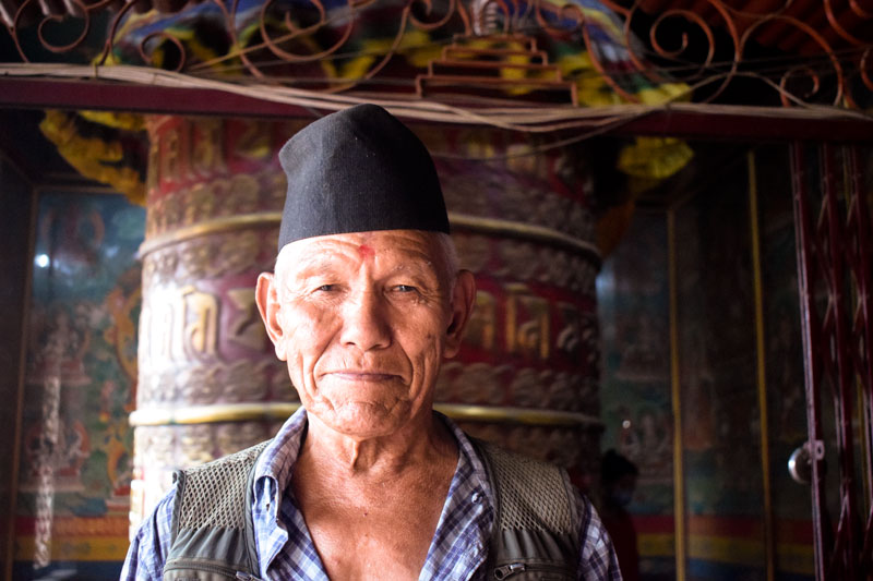 Nepali Man portrait Shot Buddhist Prayer wheel