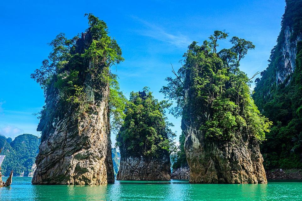 Cheow Lan Lake with three monolith rising above Andaman Sea. Khao Sak National Park. One of the most beautiful beach and place in Thailand. 