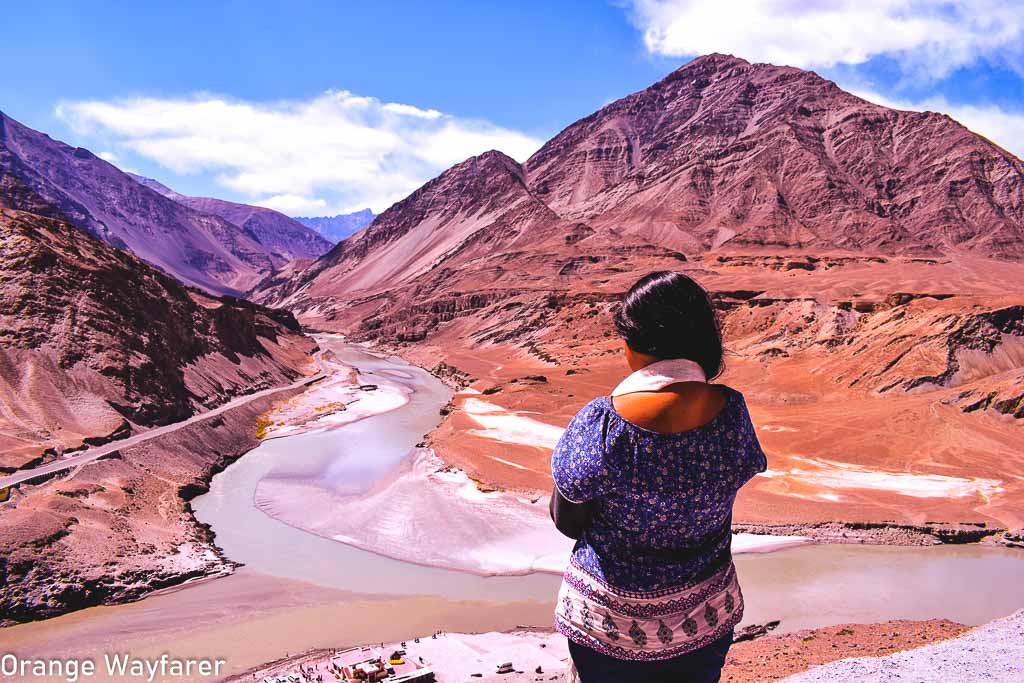 standing at Nimoo, the confluence or Sangam of Indus and Zanskar river, a day trip from Leh city: Traveling in Ladakh